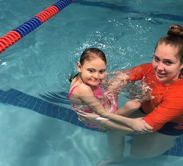 Maddie Farr with her swim instructor